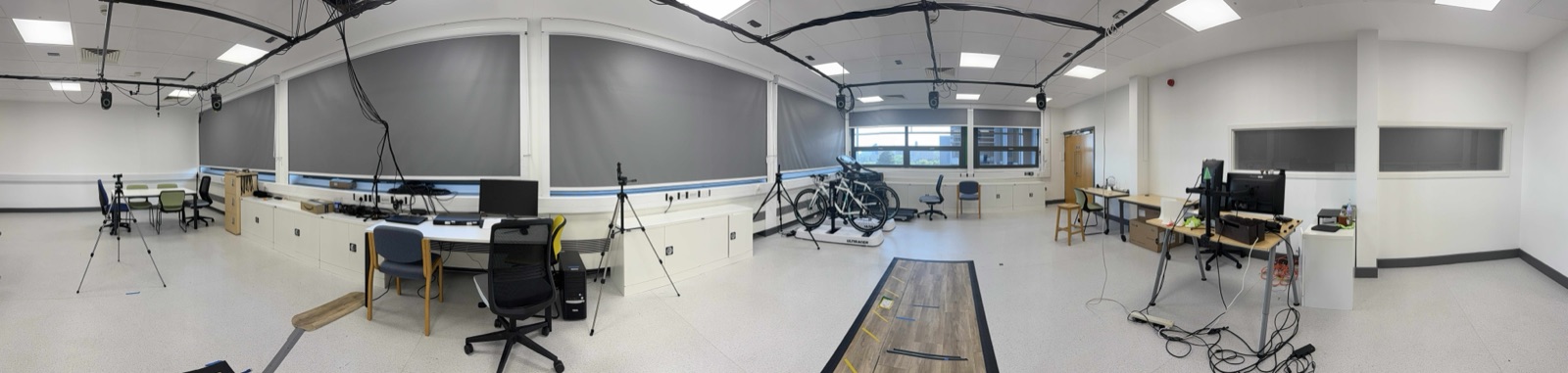 Panoramic view of the Movement Lab markerless motion-capture facility, with ceiling-mounted cameras, tripods and a walkway